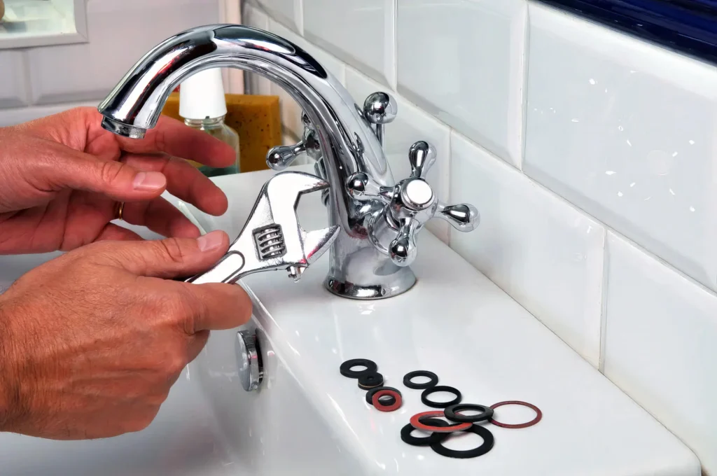 Plumber performing maintenance on a bathroom faucet in Upper Darby