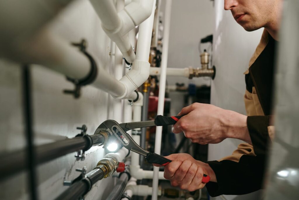 Plumbers maintaining commercial plumbing pipes in Upper Darby