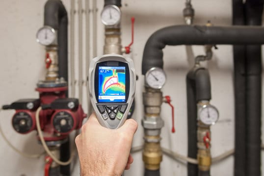 Plumber using a thermal imaging camera to inspect pipes in Upper Darby