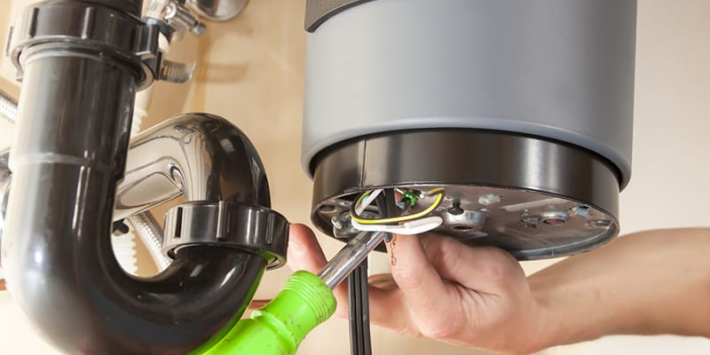 Technician repairing the heating element of a water heater in Upper Darby