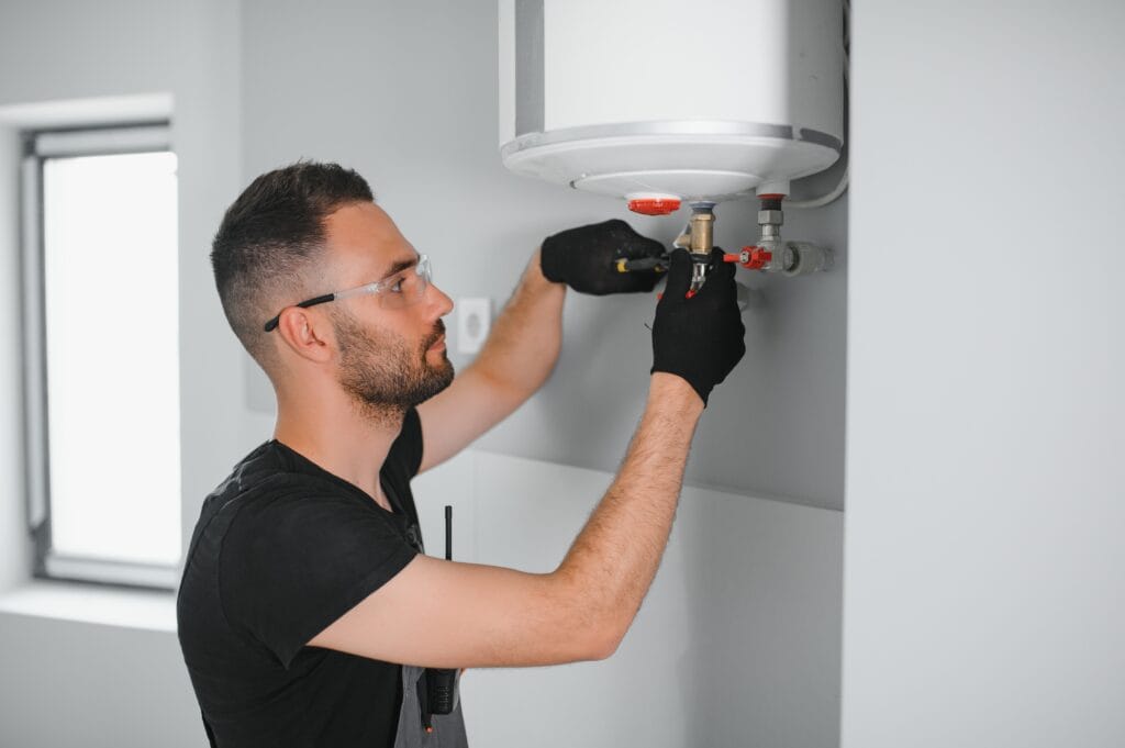 Technician performing water heater maintenance in Upper Darby