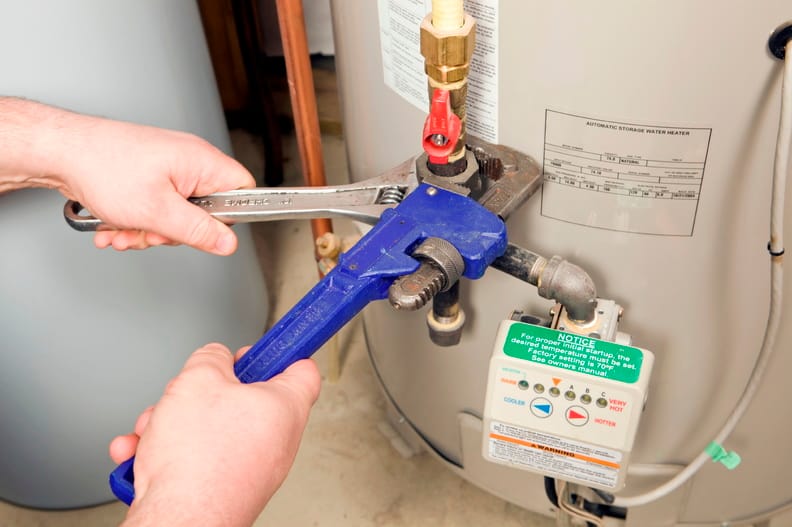 Plumber repairing a water heater valve in Upper Darby